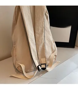 Detail of adjustable shoulder straps on a canvas backpack with high-quality buckles