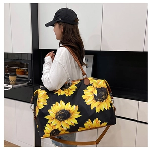 Detail of sunflower travel bag with leather handles shown in a lifestyle setting
