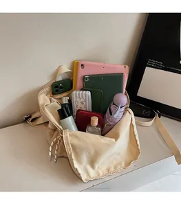 Detail view of the large capacity interior of this cream canvas backpack with daily items