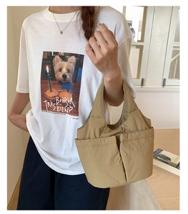 Khaki nylon bucket tote bag with large external pockets for daily commuting style
