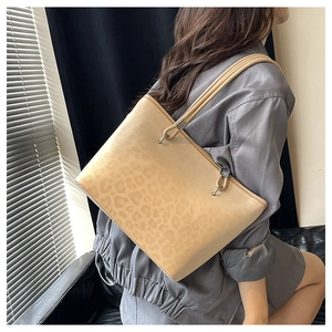 Dettaglio della borsa tote leopardata con anello in metallo argento e doppi manici da donna