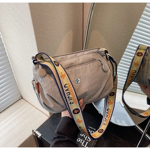 Detail of grey nylon crossbody bag featuring a jacquard patterned wide shoulder strap