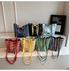 Variety of canvas tote bags with striped and floral patterns displayed on stairs