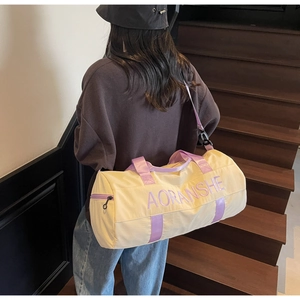 Close-up of yellow travel bag with purple straps and AORANSHE logo on stairs