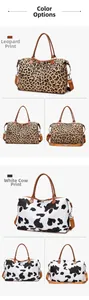 Detail view of large leopard and cow print duffel bags with shoulder straps and handles