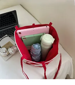 Top view of large red and white striped tote bag showing spacious interior with items
