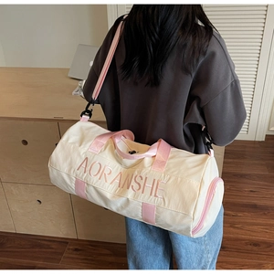 Detail of travel bag with pink AORANSHE embroidery and adjustable shoulder straps