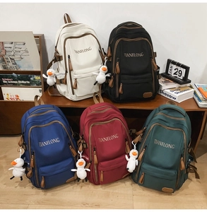 Detailed view of the five stylish nylon backpacks in various colors with duck charms
