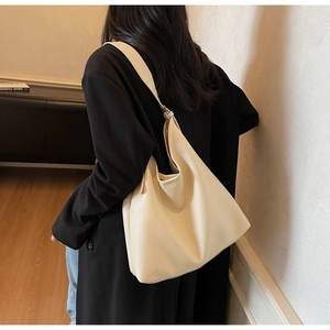 Back view of a model wearing the cream white lychee texture large leather tote bag