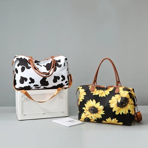 Detail of leopard and sunflower travel bags showing nylon texture and leather handles