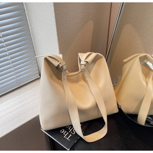 Close-up of litchi grain leather tote bag with silver buckle and adjustable strap