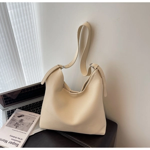 Minimalist creamy white shoulder bag with leather texture and adjustable strap detail