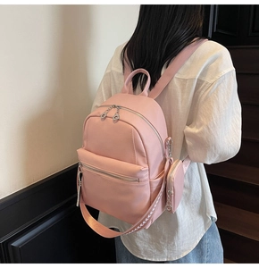 Pink lychee texture leather backpack featuring wide woven strap and matching coin purse