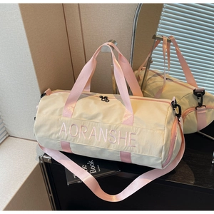 Detail showing the AORANSHE embroidery and pink straps on the beige gym bag