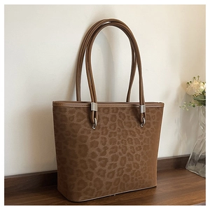 Dettaglio della borsa tote leopardata con trama in pelle scamosciata e fibbie in argento