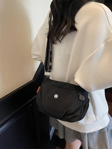 Fashionable black nylon crossbody bag with a stylish patterned wide shoulder strap for women