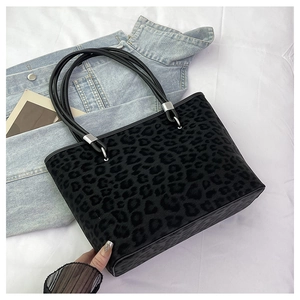 Dettaglio della borsa tote leopardata con texture in ecopelliccia e manici in pelle