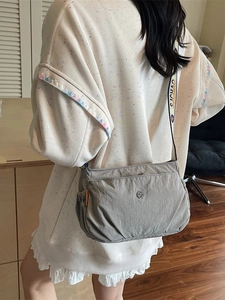 Women's grey nylon crossbody bag with stylish patterned wide strap and multiple layers