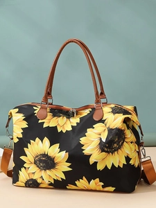 Large travel duffel bag with sunflower print and brown leather handles for gym or weekend trips