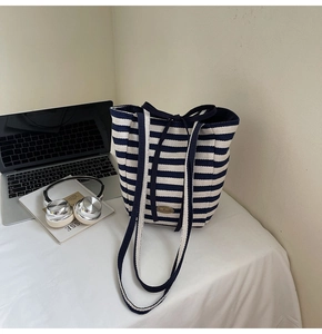 Blue and white striped canvas tote bag detail showing handmade label and large capacity