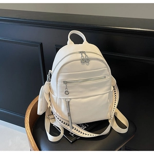 Detail of white lychee grain backpack with silver hardware and woven pattern straps