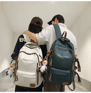 Detail of large capacity backpacks with contrast zipper trim and duck charms