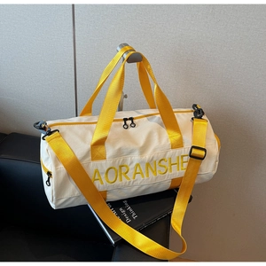 White canvas travel bag featuring yellow handles and embroidered brand detail