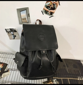 Detail of vintage faux leather backpack featuring FEIAI logo and drawstring closure