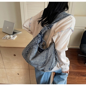 Detailed back view of a large vintage washed denim tote bag styled for casual daily wear