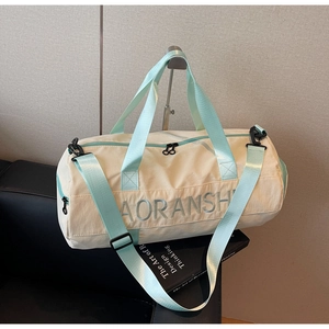 Detail of travel duffle bag on leather seat with mint green straps and Aoransh logo