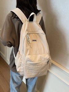 Minimalist beige nylon backpack with large capacity and stylish casual student schoolbag