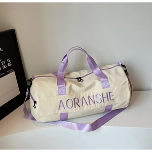 Detail of beige travel bag with purple straps showing double zippers and AORANSHE logo