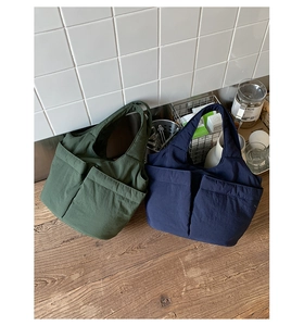 Close-up of quilted tote bags with dual front pockets on a wooden table in home setting