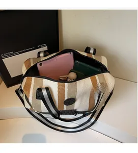 Spacious striped travel bag showing interior with tablet and phone for large capacity