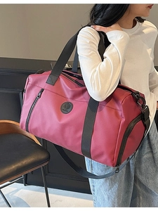 Burgundy waterproof travel bag for yoga and fitness shown in a 45-degree lifestyle view