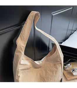 Minimalist beige tote bag featuring wide comfortable straps and a large front pocket