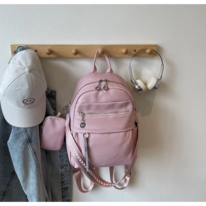 Close-up of pink lychee pattern PU leather backpack with woven wide shoulder straps