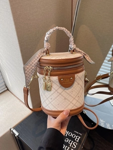 Quilted cylinder bucket bag in beige and brown with silk scarf handle and gold lock
