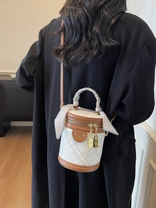 Quilted bucket bag in white and brown with silk scarf handle and gold metal hardware