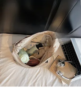 Beige nylon tote bag interior showing large capacity for laptop, umbrella and daily items