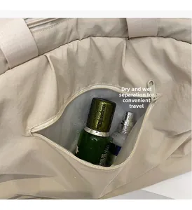 Detail view of water-resistant side pocket for dry-wet separation on beige travel bag