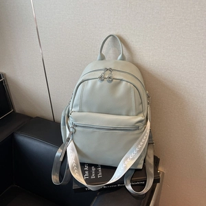 Chic sage green litchi leather backpack with stylish woven strap for urban commuting