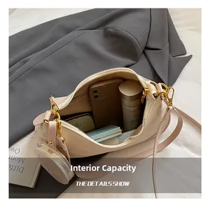 Detail view showing large capacity of the cream crossbody bag with makeup and phone