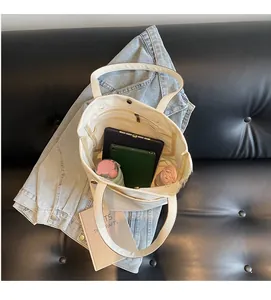Internal view showing large capacity and zipper pocket of the white canvas tote bag
