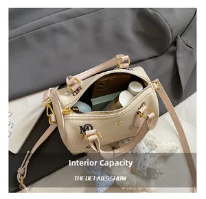 Internal view of beige Boston bag showing spacious capacity for phone and cosmetics