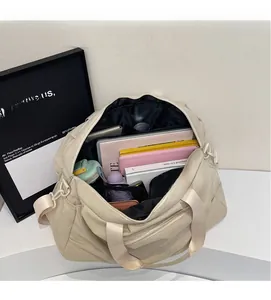 Top view of spacious beige travel bag interior showing laptop and item compartments