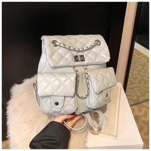 Detailed view of quilted faux leather backpack with silver chain and metal lock