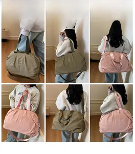 Detailed views of the olive green and pink travel bag worn as a shoulder and handbag