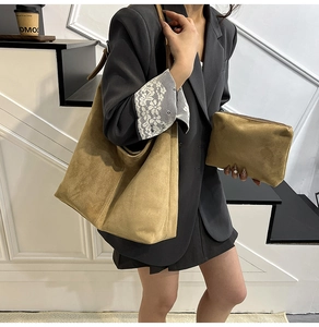 Side view of a khaki suede tote bag and matching pouch on a shoulder for daily commute