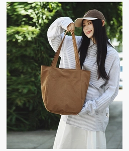 Brown canvas tote bag detail showing heavy-duty fabric and stitching for daily commute